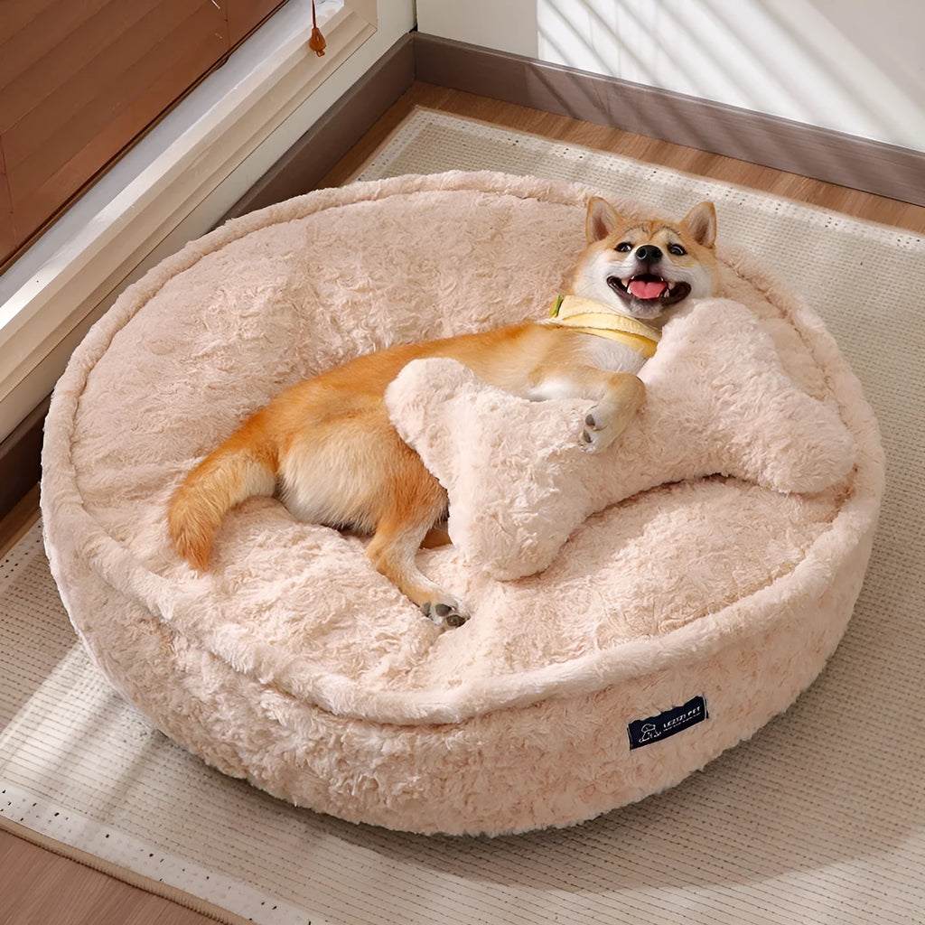 Round nest-style pet bed with a removable washable cover in a milk tea colour.