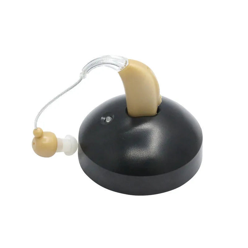 Black rechargeable hearing aid amplifier with silicone earplugs and a USB charging cable.