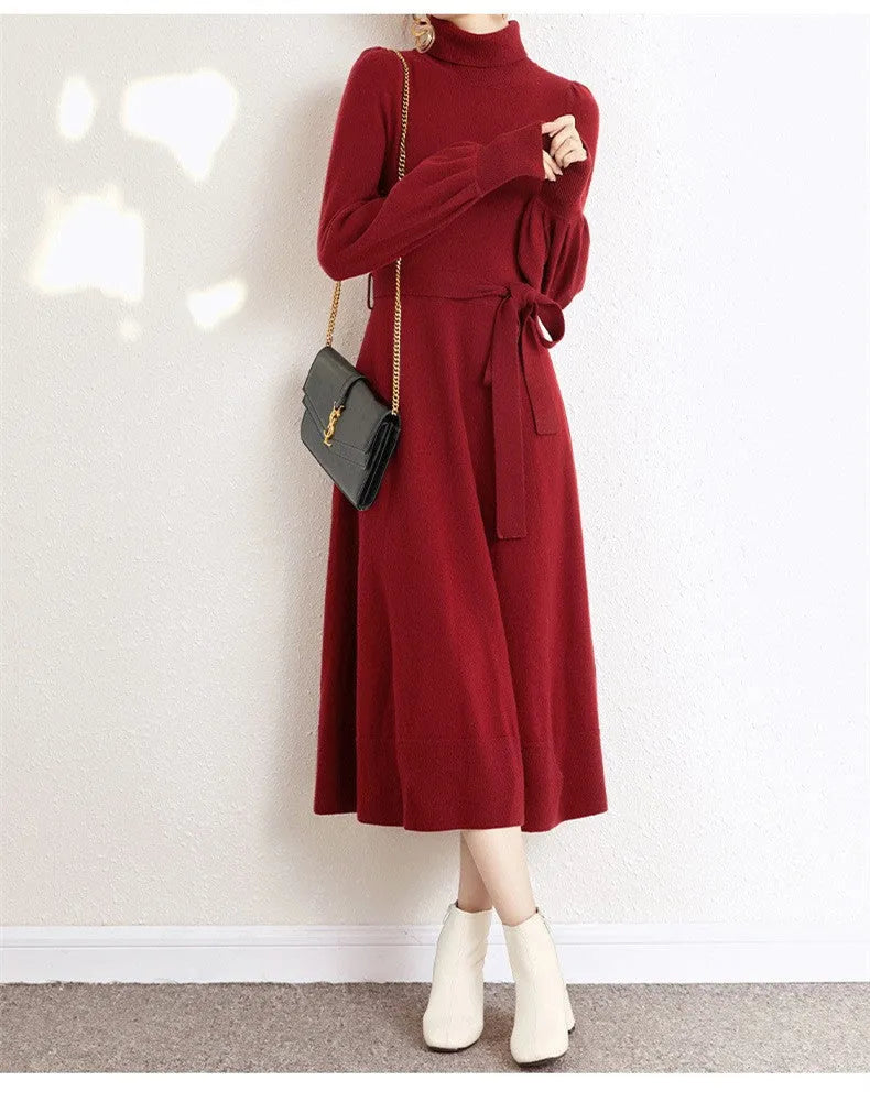 Rose red turtleneck knit dress with long sleeves, elastic waist, and a flared midi-length skirt.