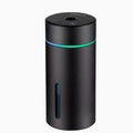 Compact aluminium car humidifier diffuser with colourful light and USB cable on a desk.