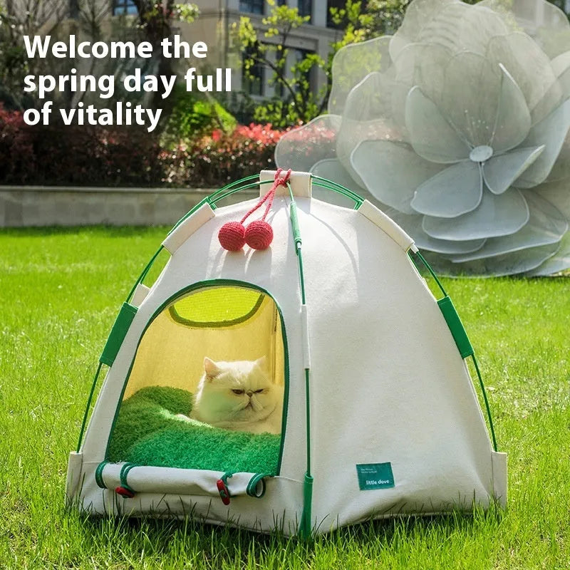 Grey dome-shaped cloth cat tent with a thick padded floor inside, set on a carpet.