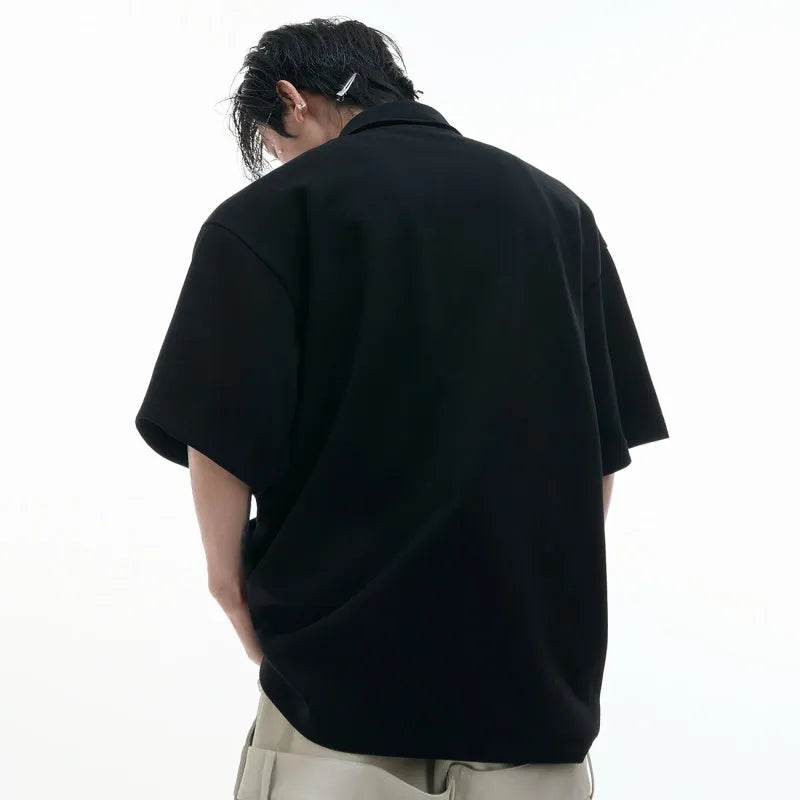 Men's loose fit grey polo shirt with a deconstructed multi-collar and a geometric pattern on the chest.