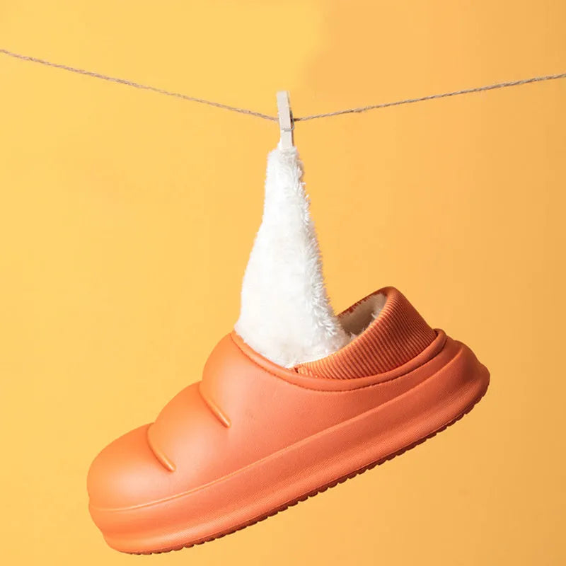 Women's waterproof EVA slippers in various colours with plush lining and a non-slip flat sole.