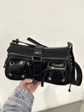 Black women's underarm baguette bag with adjustable shoulder strap showing internal zippered change compartment