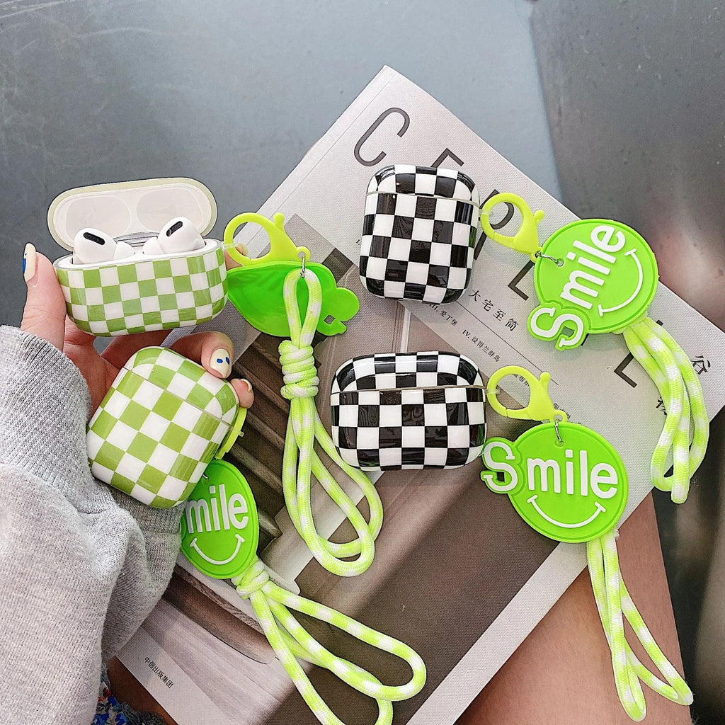 Black and green checkerboard patterned TPU protective case for Apple AirPods with optional lanyard and loop pendant attachments.