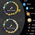 Two natural stone beaded bracelets showing different zodiac sign charms on a plain background.