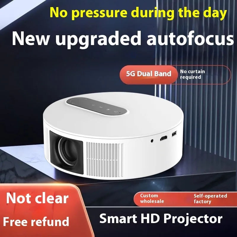 White HD projector unit with remote control on a table for home cinema use.