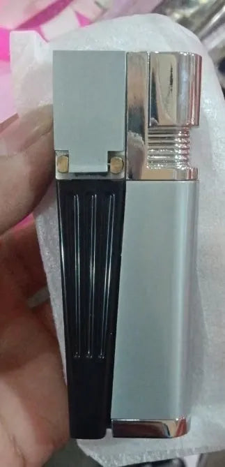 Silver foldable metal pipe lighter in open position showing flame mechanism and storage compartment.