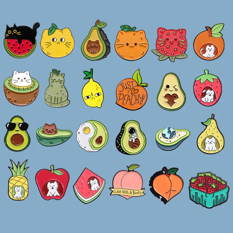 Colourful cartoon fruit and letter design on a metal brooch pin with a secure clasp.