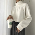 Women's loose half-high collar long sleeve top in solid apricot colour on a hanger.