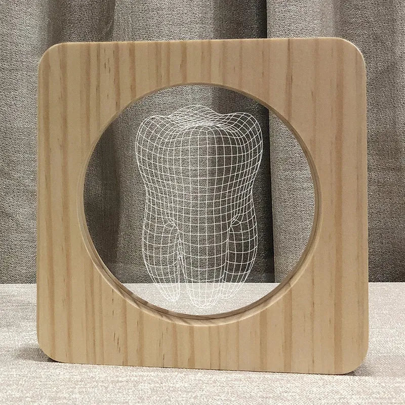 Wood colour tooth-shaped acrylic USB night lamp on a surface