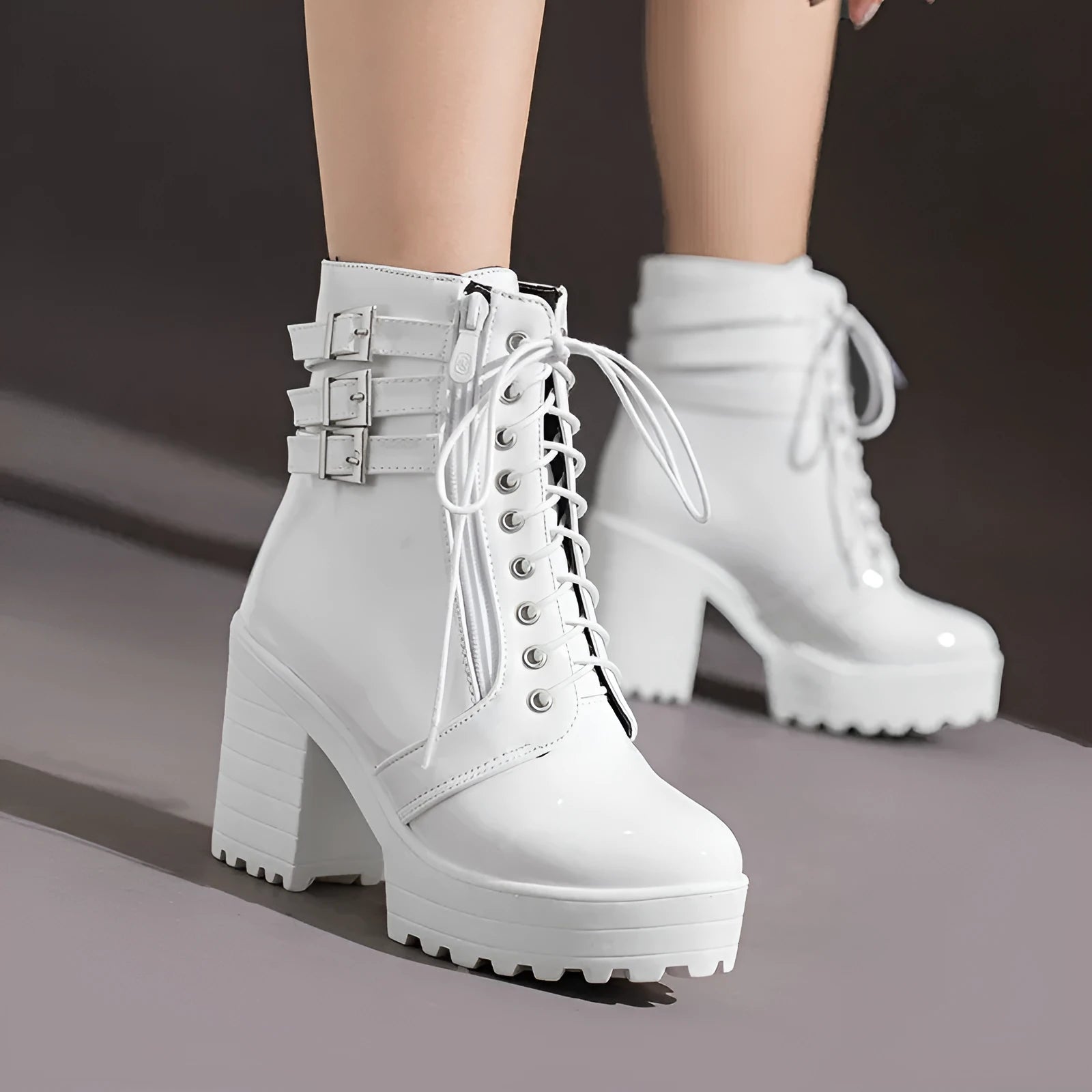Women's black thick-heeled ankle boots with lace-up front and round toe on a waterproof platform