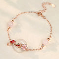 S925 sterling silver bracelet with white chalcedony beads and a gold-toned koi fish charm.