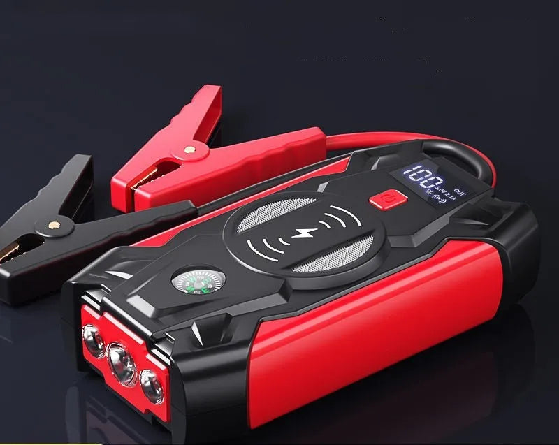Red portable car jump starter power bank with heavy-duty jumper cables and a storage case.