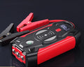 Red portable car jump starter power bank with heavy-duty jumper cables and a storage case.