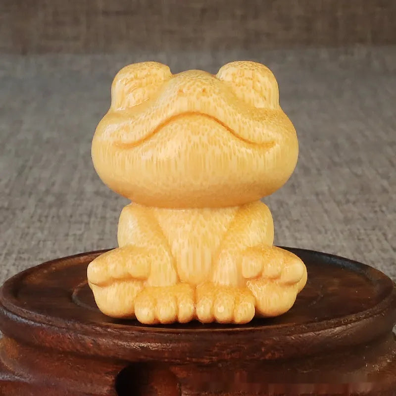 Solid bamboo smiling frog carving ornament measuring 5cm high with cartoon design