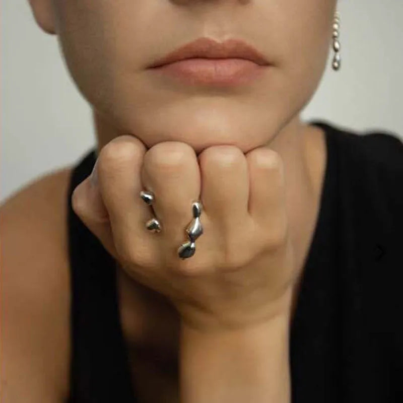 Brass ring with a spherical design on a circular band, shown in gold and silver finishes.