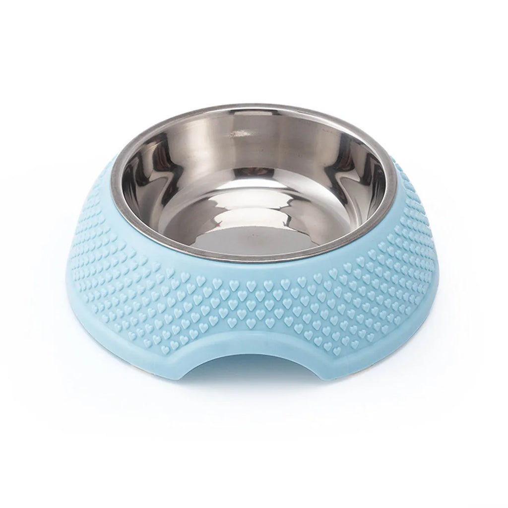 Set of four coloured stainless steel pet bowls with non-slip bases on a table.