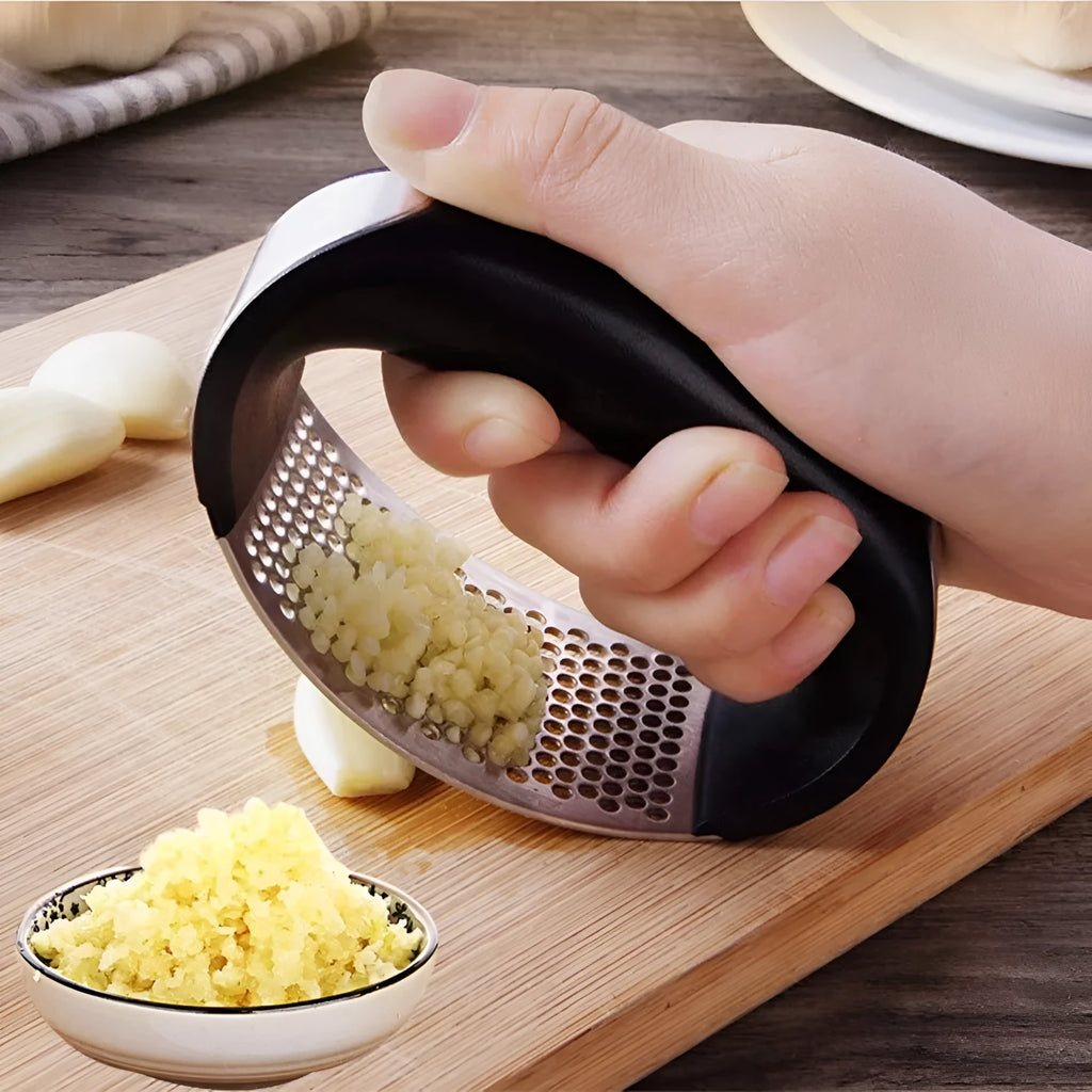 Stainless steel garlic press with ergonomic handle in available colours for kitchen use