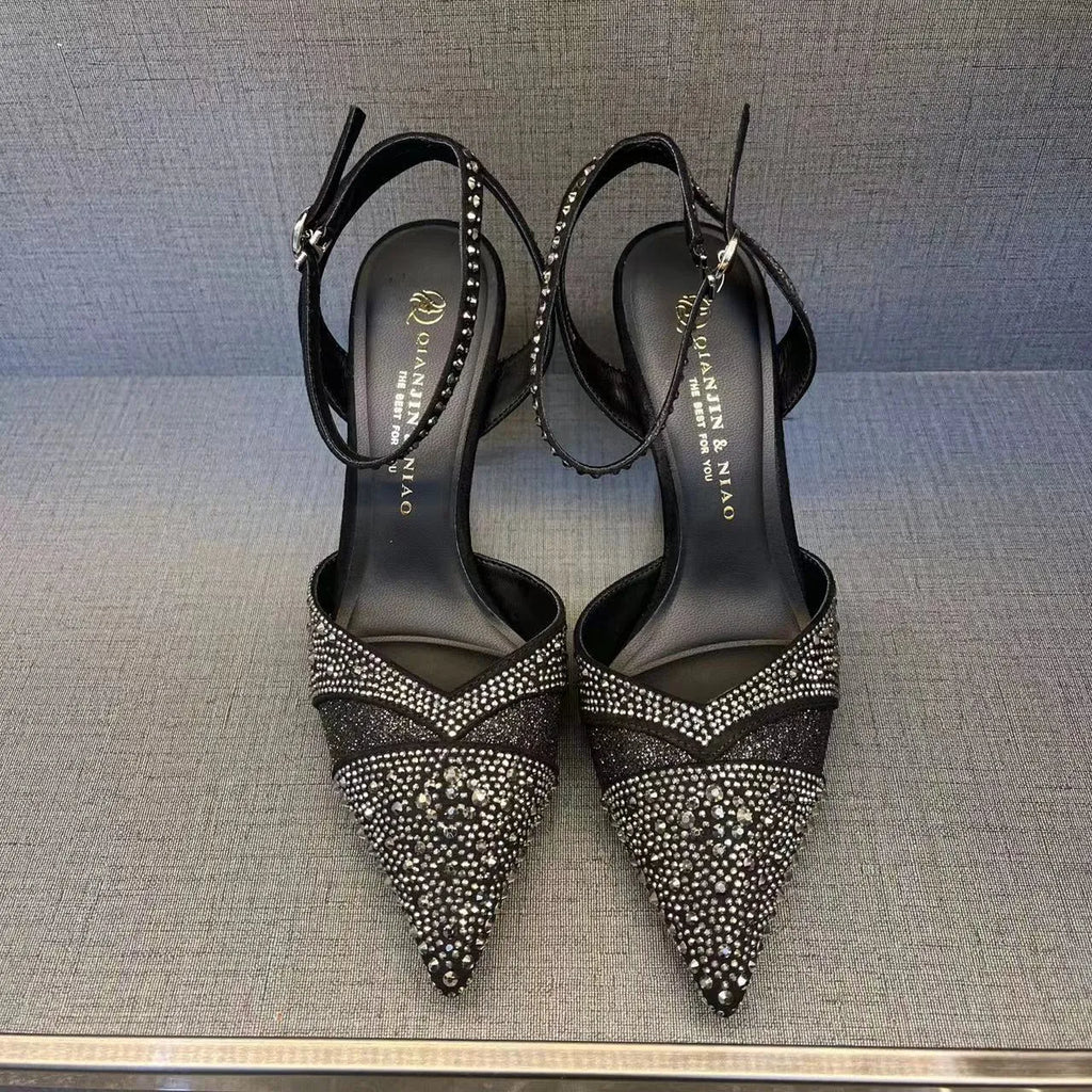 Women's black high-heeled shoes with a red sole, showing stiletto heel and pointed toe design.