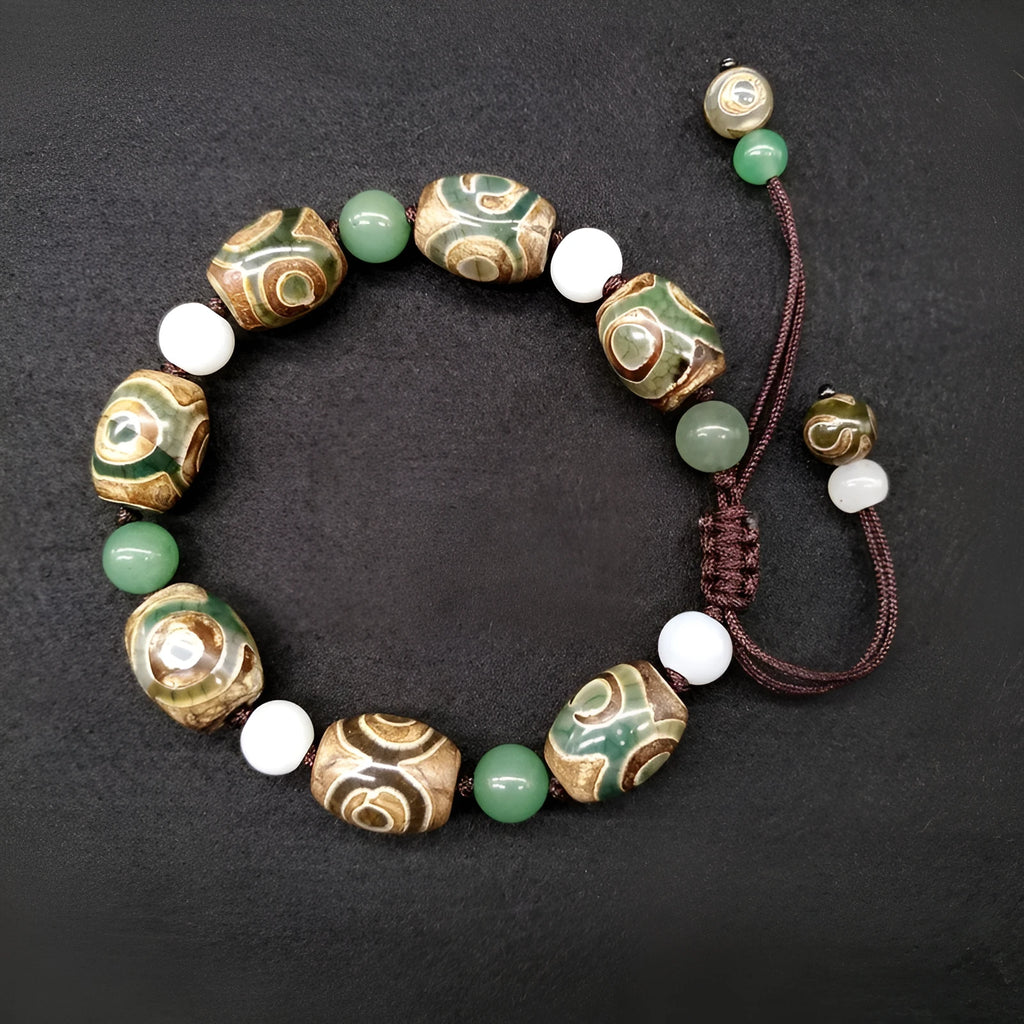 Green agate ethnic bracelet with a large three-eye bead and hand-woven band.