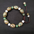 Green agate ethnic bracelet with a large three-eye bead and hand-woven band.