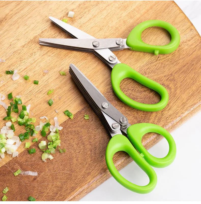Stainless steel multi-layer herb scissors with green handles for chopping green onions and seaweed.