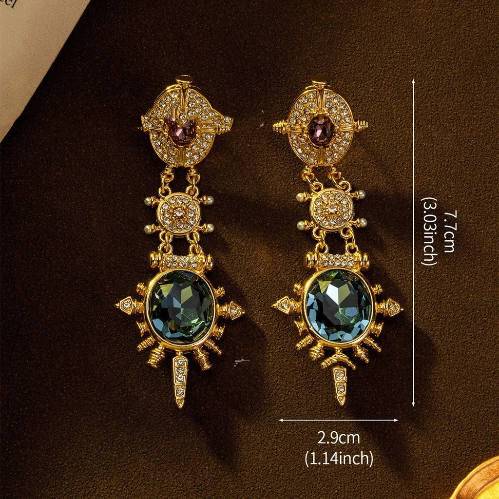 A pair of gold retro-style stud earrings with a geometry shape and round design elements.