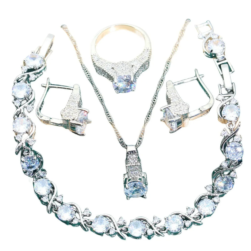 Bridal zircon and alloy four-piece jewellery set showing necklace, earrings, bracelet, and ring in white colour