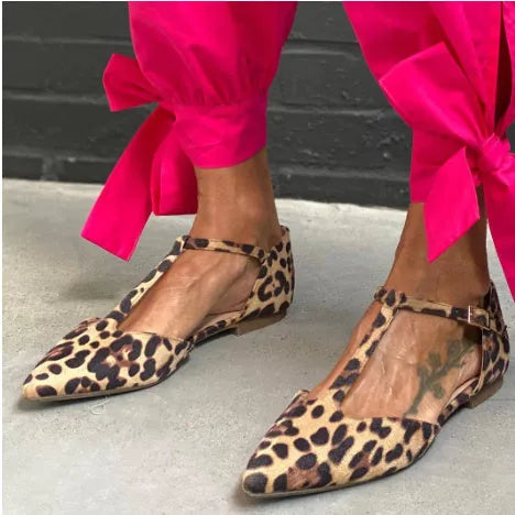 Women's black leopard print pointed toe pumps with a chunky low block heel and cross ankle straps.