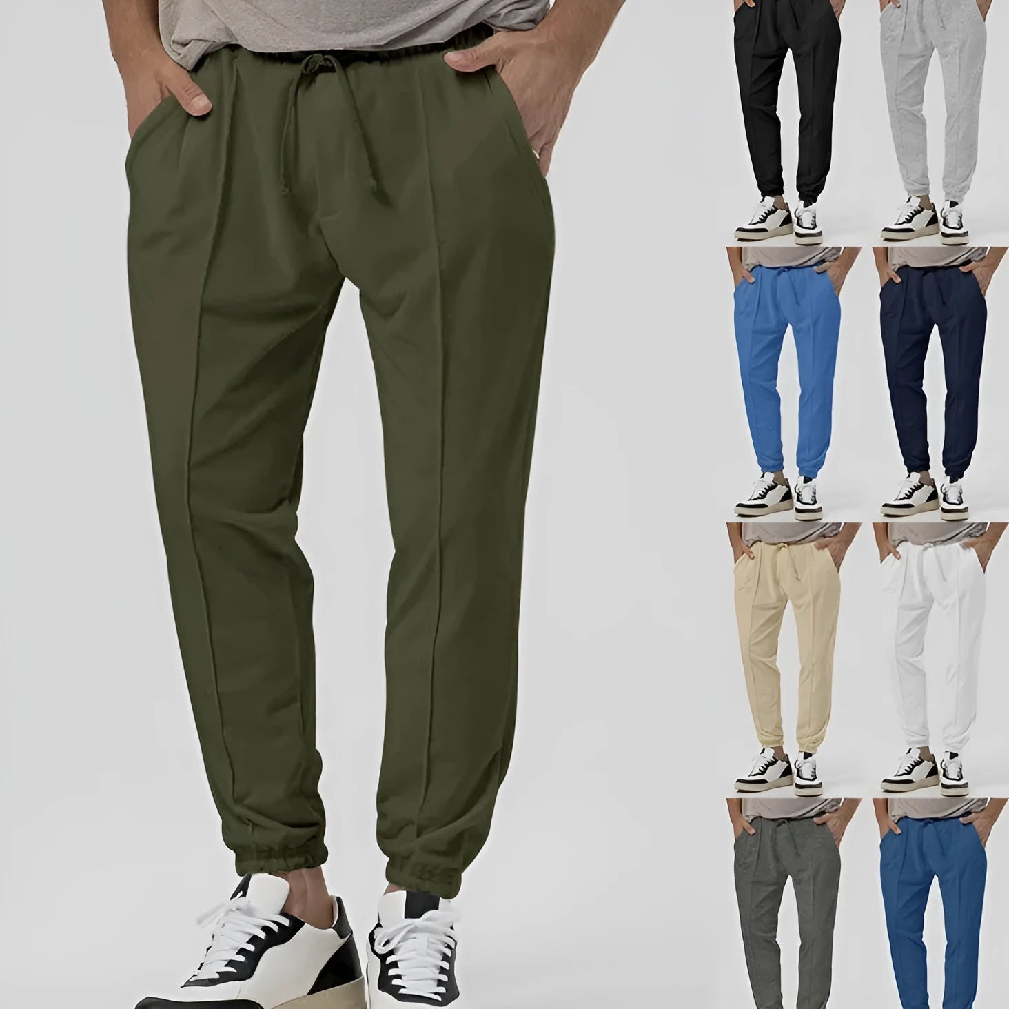 Men's grey loose tapered casual track sweatpants with a straight leg and elastic waistband.