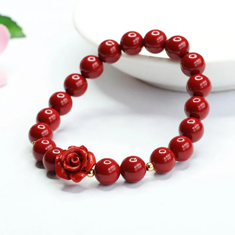 Close-up of a women's natural cinnabar bracelet with a detailed 8mm purple gold sand rose centrepiece.