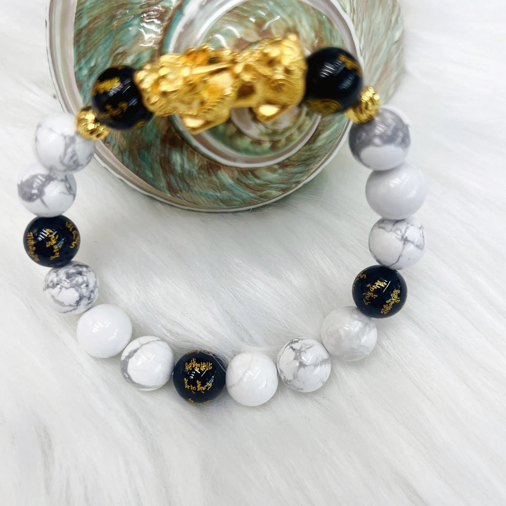 Vintage couple bracelet with white turquoise and black agate stones on a wrist.