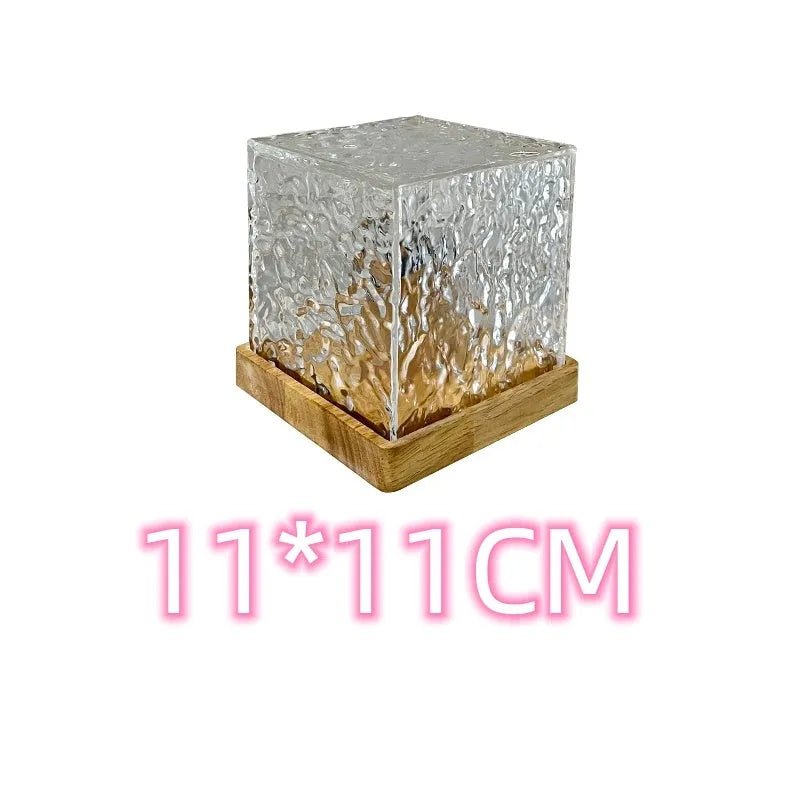 LED water ripple night light with rotating crystal projection and remote control on wooden surface