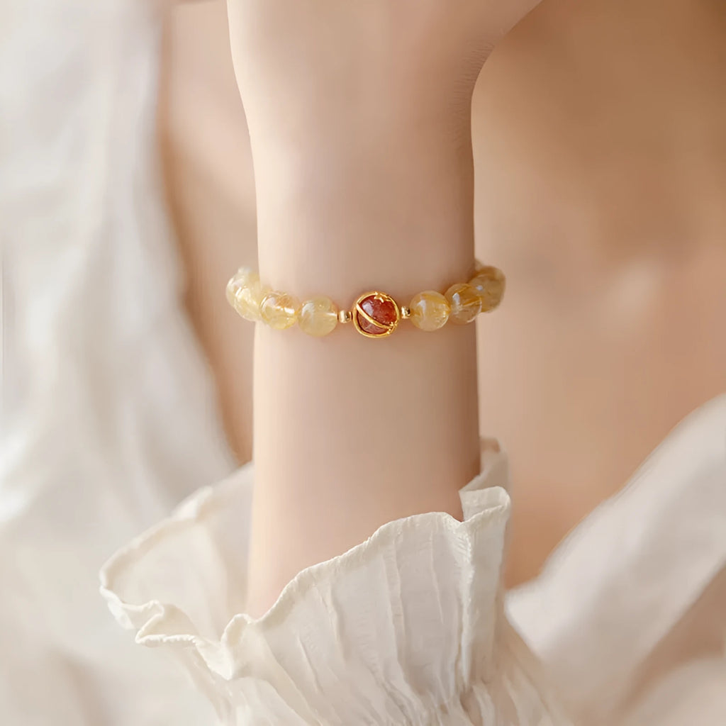 Gold rutilated quartz crystal bracelet with diamond-cut beads in 6mm and 8mm size options.