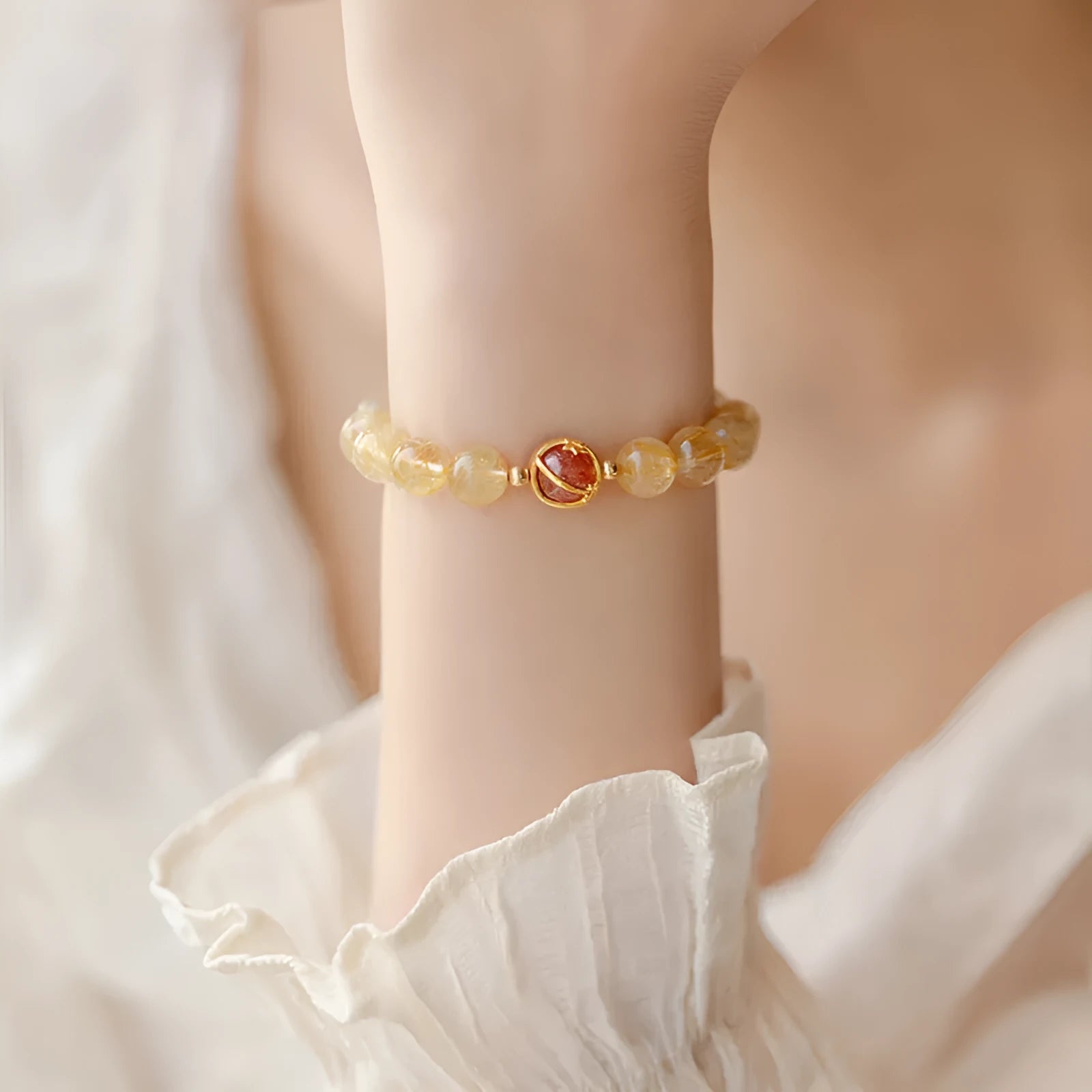 Gold rutilated quartz crystal bracelet with diamond-cut beads in 6mm and 8mm size options.
