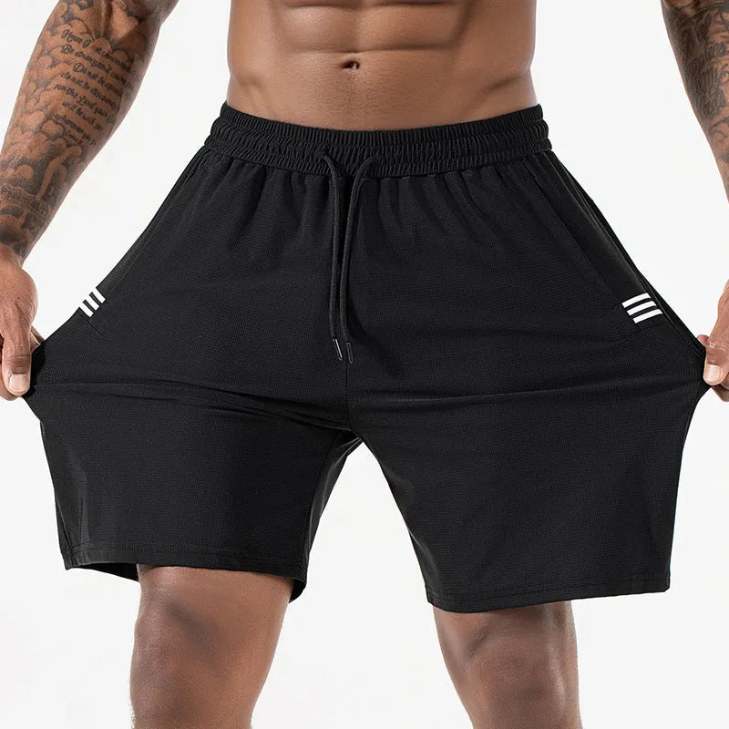 Man wearing black ice silk quick-drying sports shorts with drawstring waist.