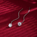Round zirconium stud earrings with tassel rhinestone hanging in white gold colour on a geometric silver base