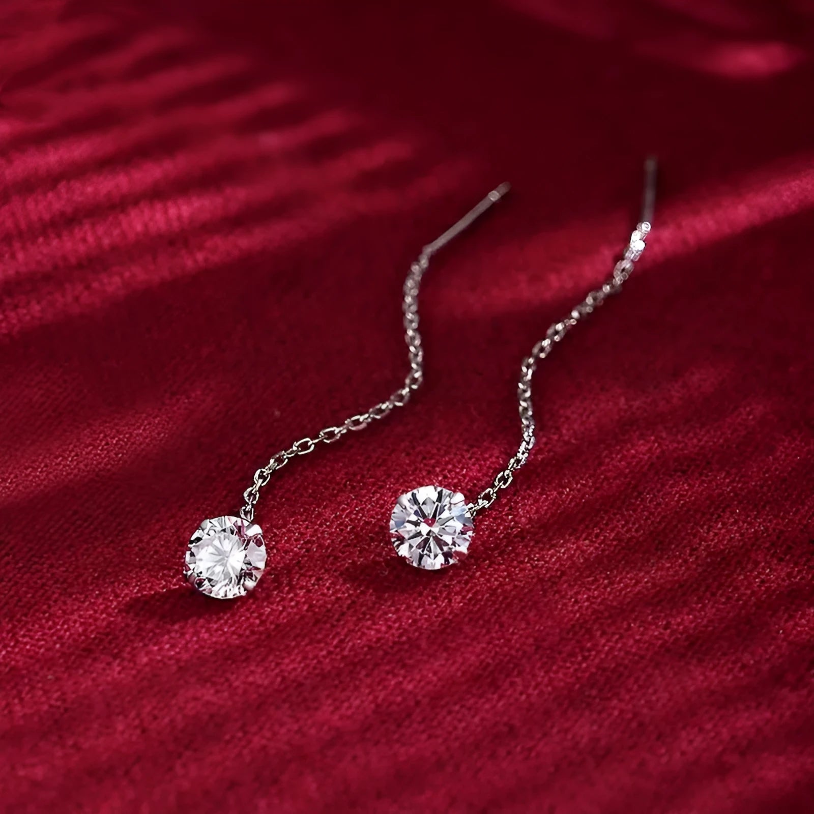 Round zirconium stud earrings with tassel rhinestone hanging in white gold colour on a geometric silver base