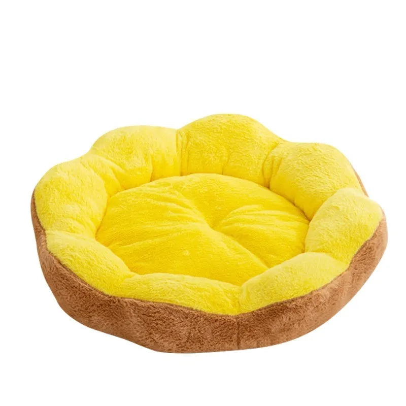 A thick grey and black plush round cat bed nest with raised sides on a wooden floor.
