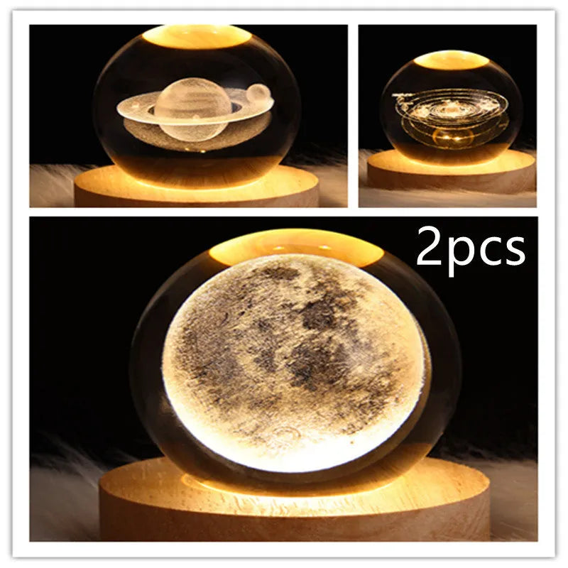 LED galaxy crystal ball night light with 3D planet designs on a table