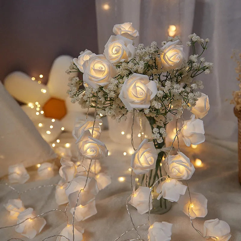 Battery-powered LED fairy lights with ten pink PV foam roses on a 1.5-metre wire for indoor decoration.