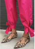 Women's black leopard print pointed toe pumps with a chunky low block heel and cross ankle straps.