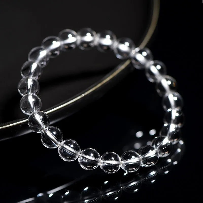 Natural white crystal bracelet with round beads, showing unisex geometry design on a wrist.