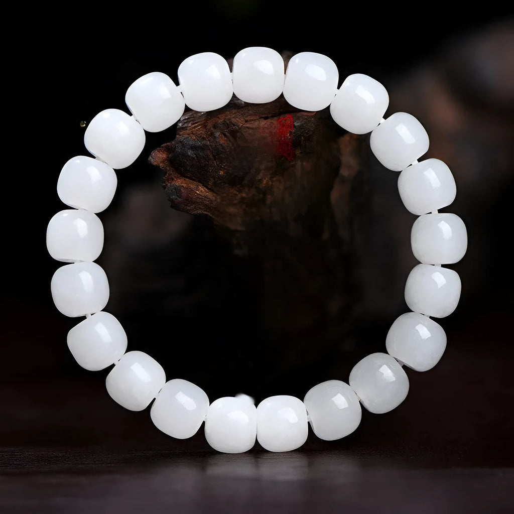 White Hetian jade barrel beads bracelet laid flat, showing bead sizes 5x6mm, 7x8mm, and 8x10mm.