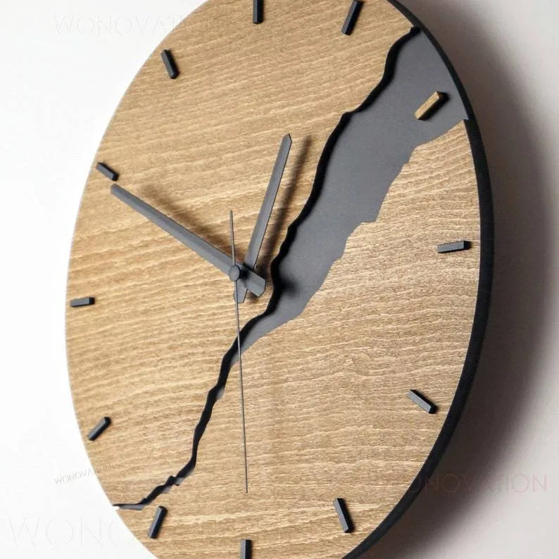 Modern wooden wall clock with a cracked surface design on a plain wall.