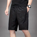 Men's loose-fit printed sports shorts in polyester fabric available in black, grey, or blue colours