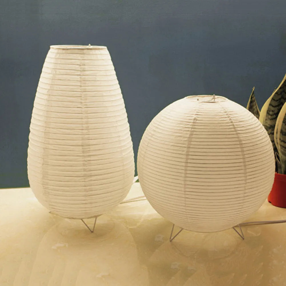 White rice paper plug-in table lamp with traditional shade on wooden surface
