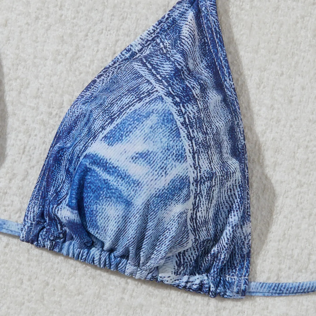 Denim blue printed women's bikini set with strap design on a mannequin.