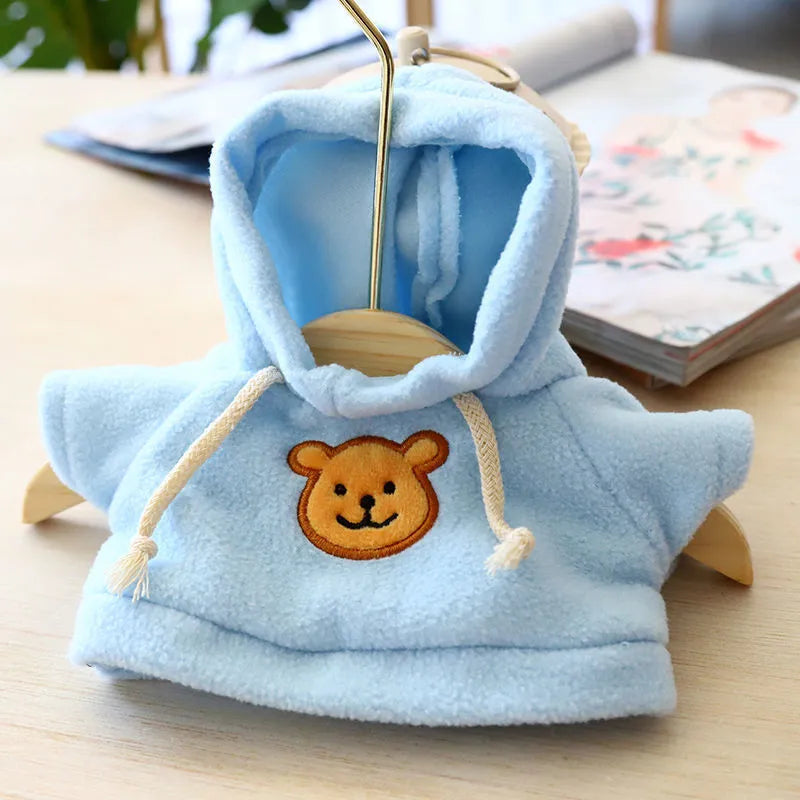 A dog wearing a soft cloth zip-up hoodie sweater in a choice of colours including a grey bear print.
